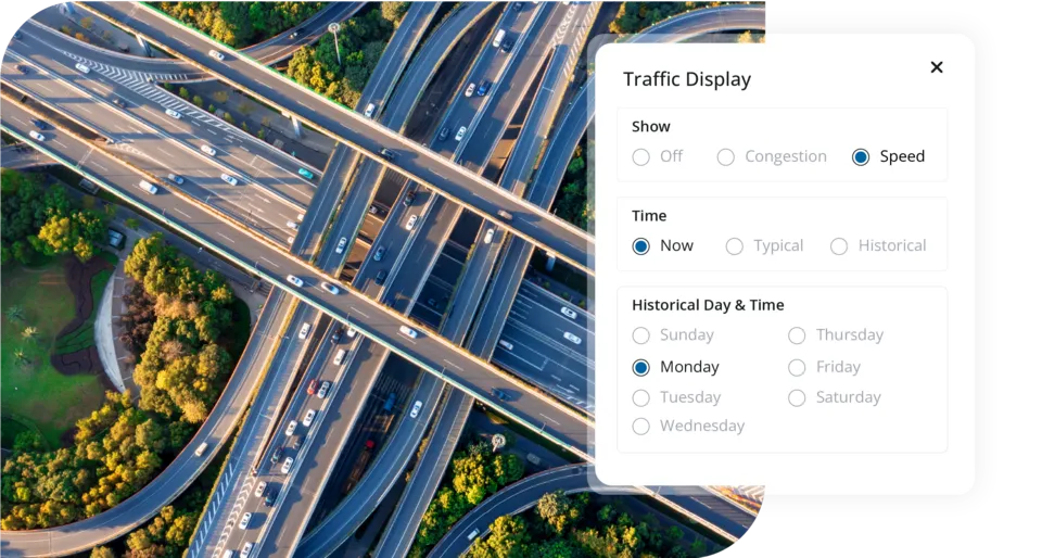 Aerial view of multi-lane highway with traffic display panel showing speed, congestion, and historical data options
